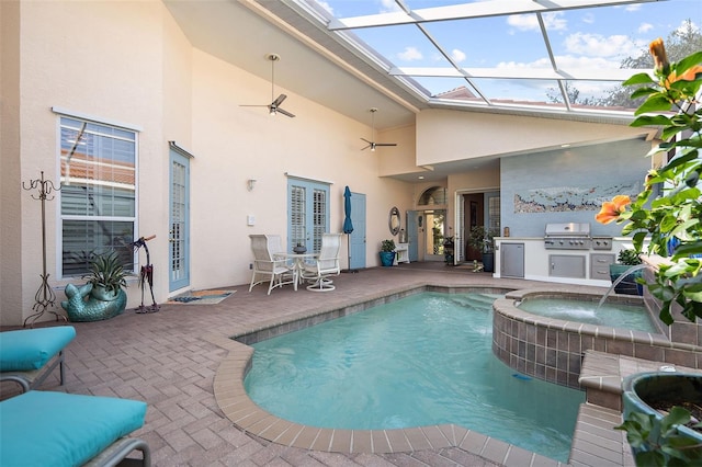 view of pool with an in ground hot tub, an outdoor kitchen, a lanai, a patio, and a grill