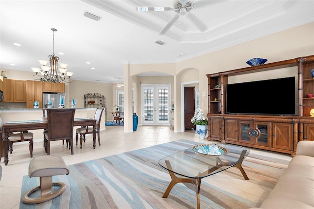 living room with ceiling fan with notable chandelier, ornamental molding, and light tile patterned flooring