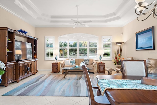 interior space with a raised ceiling, crown molding, and ceiling fan