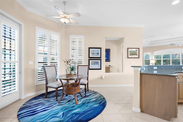 dining space with a healthy amount of sunlight, ornamental molding, and light tile patterned floors