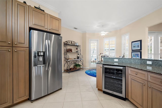 kitchen featuring dark stone counters, stainless steel refrigerator with ice dispenser, wine cooler, light tile patterned floors, and ornamental molding