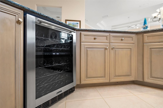 room details featuring light brown cabinetry, crown molding, and wine cooler