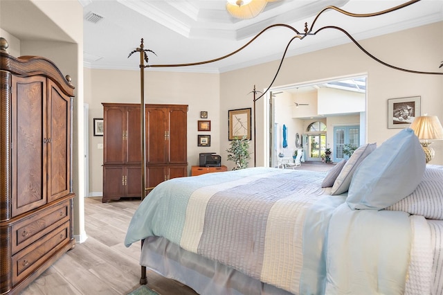 bedroom with light hardwood / wood-style floors and crown molding