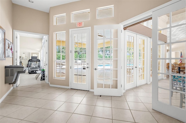 entryway with french doors and light tile patterned floors