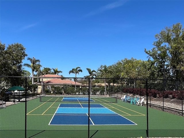 view of tennis court featuring fence