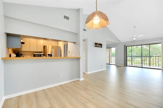 unfurnished living room with ceiling fan, light hardwood / wood-style floors, and high vaulted ceiling