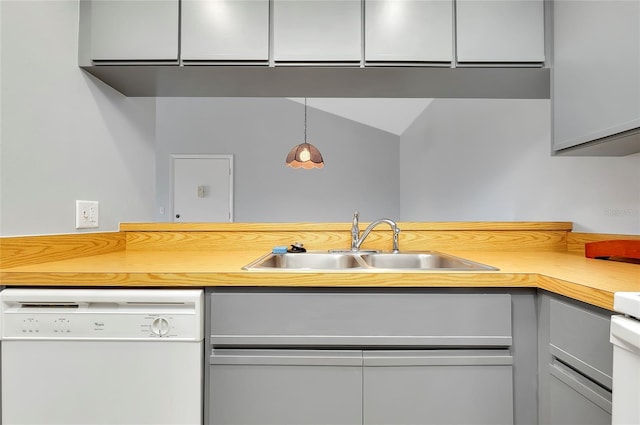 kitchen with gray cabinetry, sink, white dishwasher, and hanging light fixtures