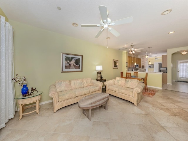 living room with ceiling fan and light tile patterned floors