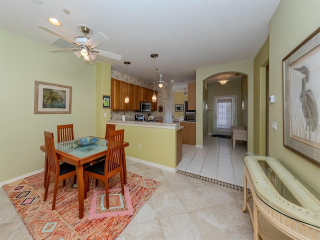 tiled dining area featuring ceiling fan