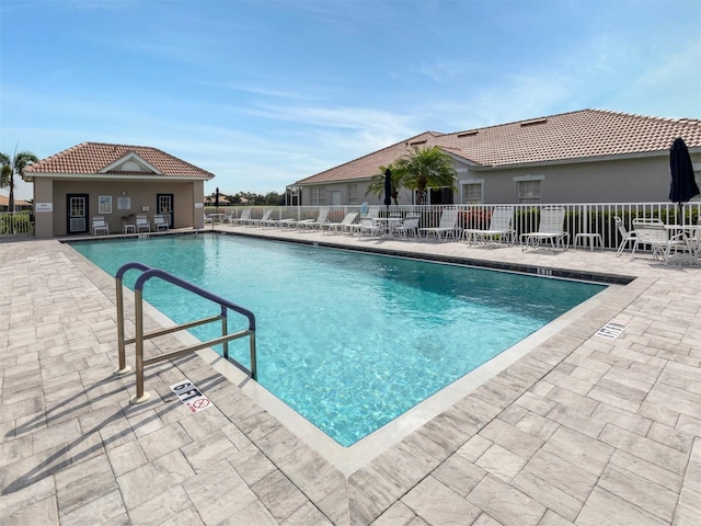 view of pool featuring a patio area and an outdoor structure