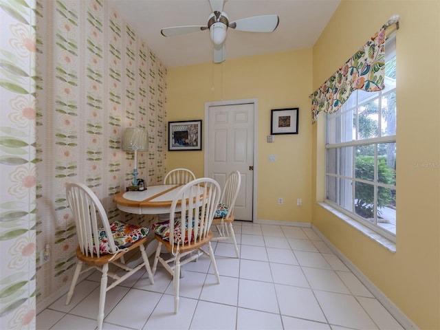 tiled dining space featuring ceiling fan