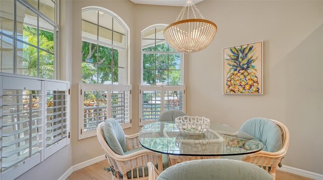 dining area featuring a notable chandelier and light hardwood / wood-style flooring