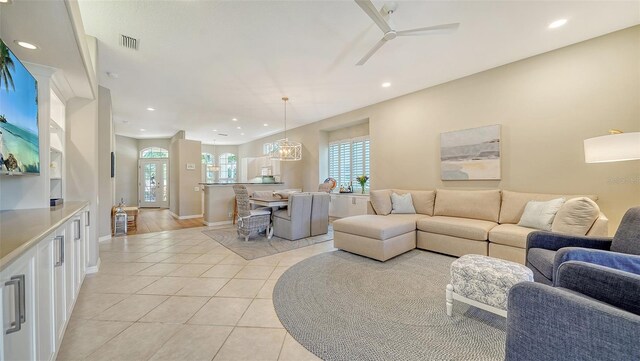 living room with light tile patterned floors and ceiling fan