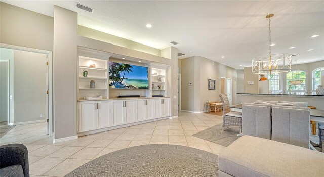 living room with built in shelves and light tile patterned flooring