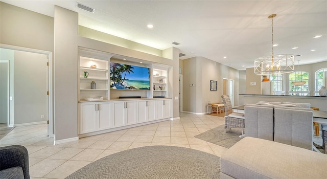 living room featuring light tile patterned floors, built in shelves, recessed lighting, visible vents, and baseboards