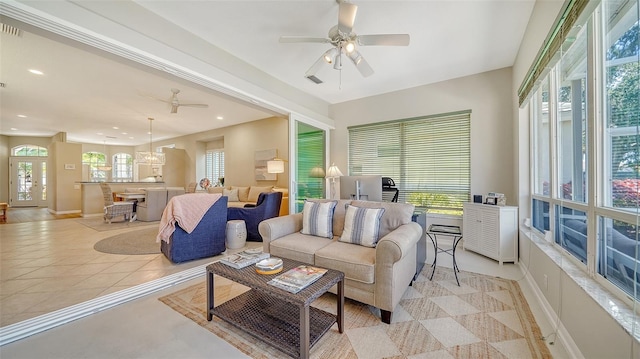 living room featuring plenty of natural light, baseboards, a ceiling fan, and light tile patterned flooring