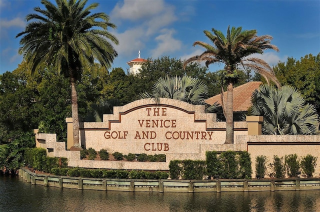 community / neighborhood sign featuring a water view