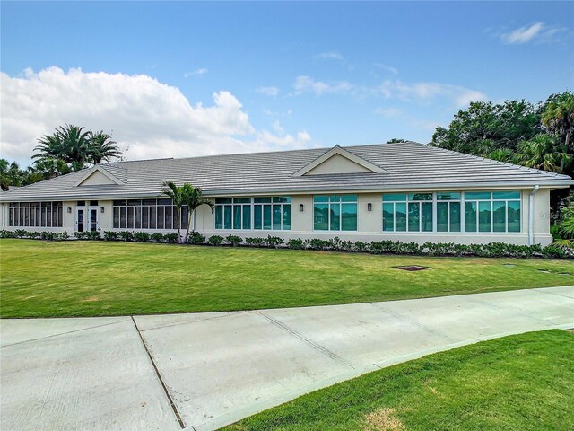 ranch-style home with a front lawn