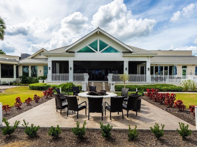 view of patio with an outdoor fire pit and fence