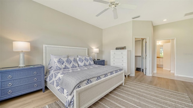 bedroom with light wood-style flooring, visible vents, a spacious closet, and baseboards