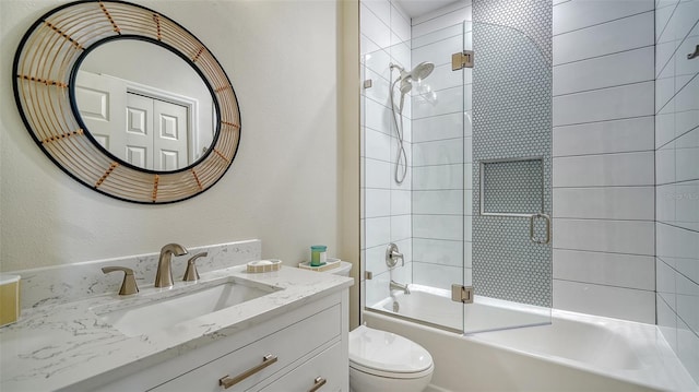 full bathroom with enclosed tub / shower combo, vanity, and toilet