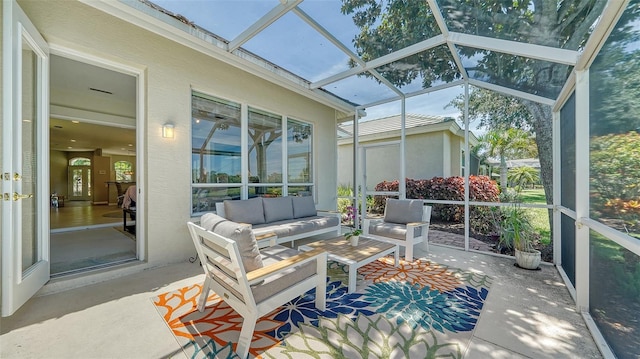 sunroom / solarium featuring lofted ceiling with skylight and a wealth of natural light