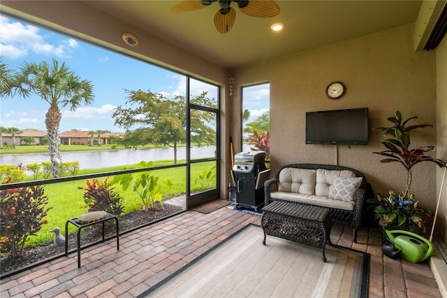 sunroom / solarium featuring ceiling fan