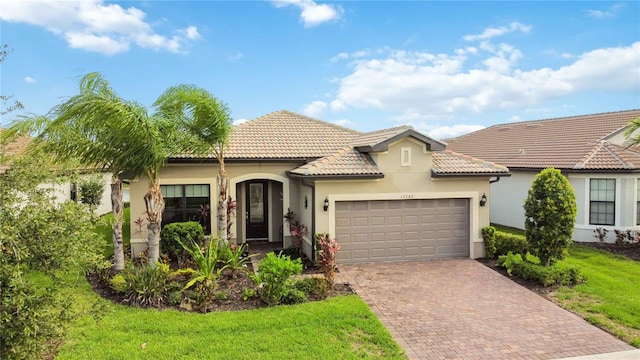 view of front of home featuring a garage and a front lawn