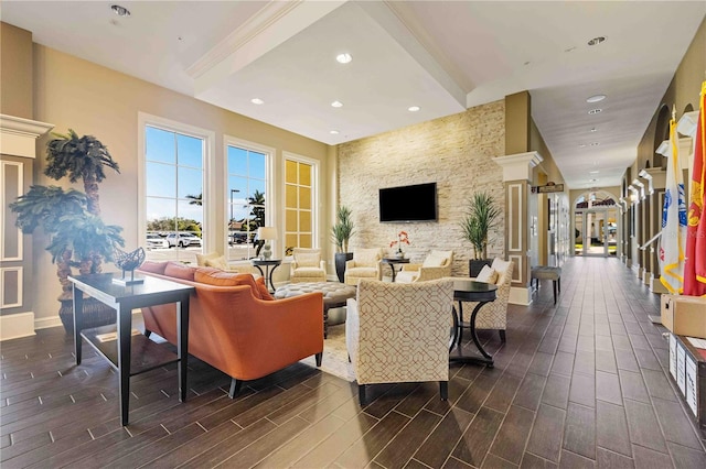 interior space featuring beam ceiling and ornate columns