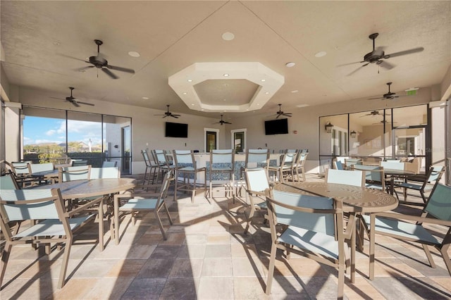 dining area with a raised ceiling