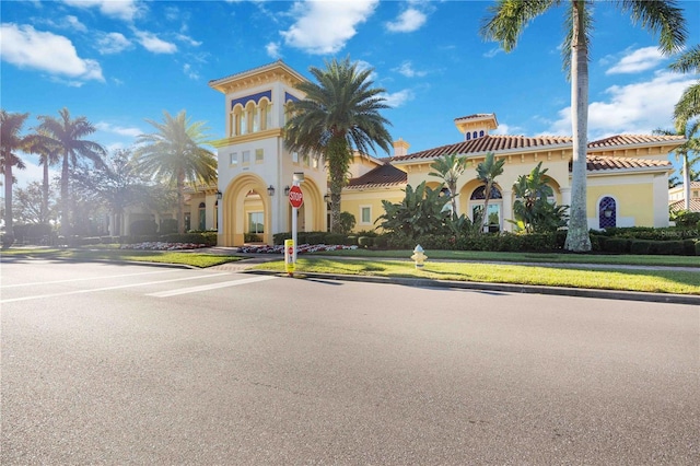 mediterranean / spanish house featuring a front yard