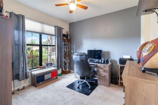 carpeted office featuring ceiling fan