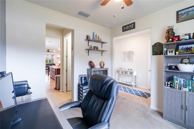 office area featuring light carpet and ceiling fan