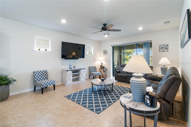 living room with ceiling fan and tile patterned flooring