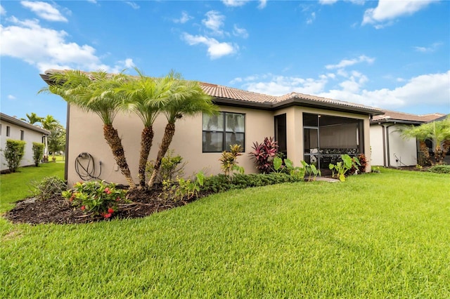 rear view of property featuring a lawn