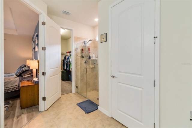 bathroom featuring a shower with shower door