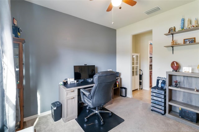 carpeted office featuring ceiling fan