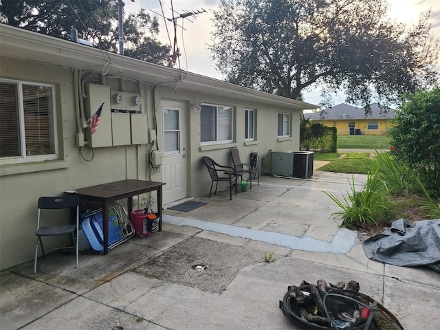 patio terrace at dusk featuring cooling unit