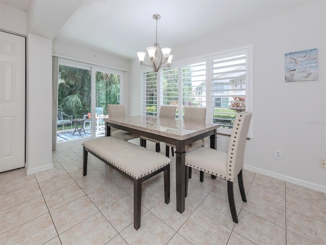 dining area featuring a notable chandelier, plenty of natural light, and light tile patterned flooring