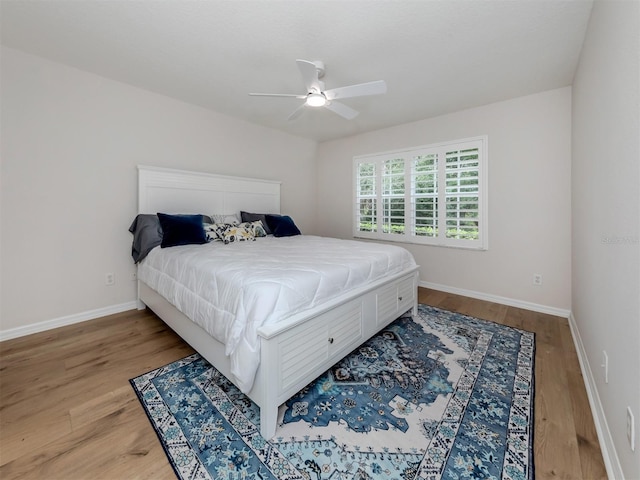 bedroom with ceiling fan and light hardwood / wood-style floors