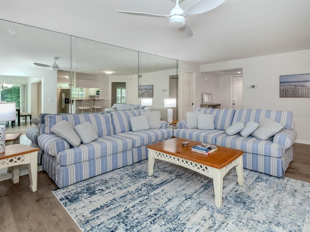 living room featuring hardwood / wood-style floors, ceiling fan, and a healthy amount of sunlight