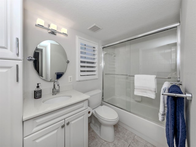 bathroom with vanity, visible vents, tile patterned flooring, a textured ceiling, and toilet