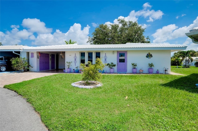 single story home featuring a front yard and a carport