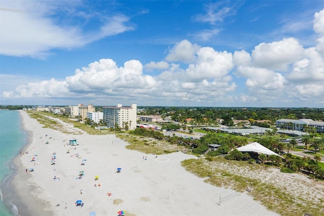 birds eye view of property featuring a beach view and a water view