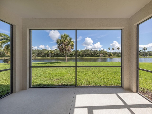 unfurnished sunroom with a water view