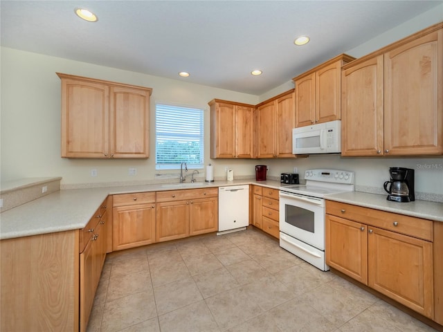 kitchen featuring light tile patterned floors, light brown cabinetry, sink, and white appliances