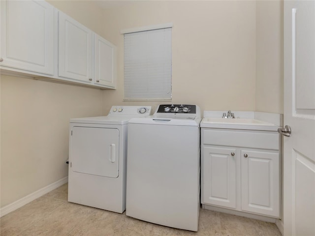 laundry area with cabinets, light tile patterned flooring, washer and clothes dryer, and sink