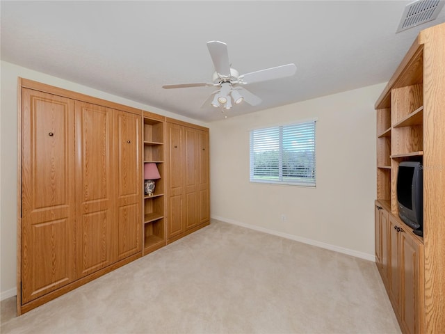 unfurnished bedroom featuring ceiling fan and light colored carpet