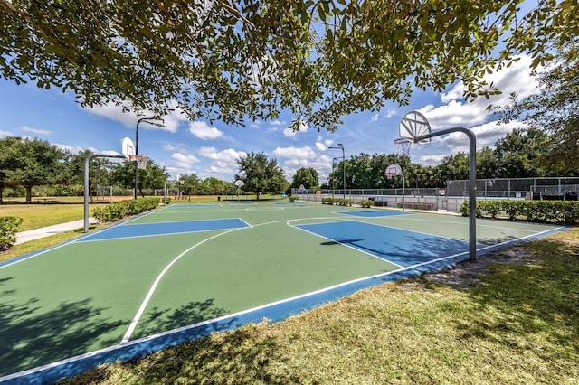 view of sport court featuring a yard