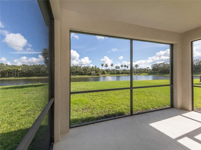 unfurnished sunroom featuring a water view